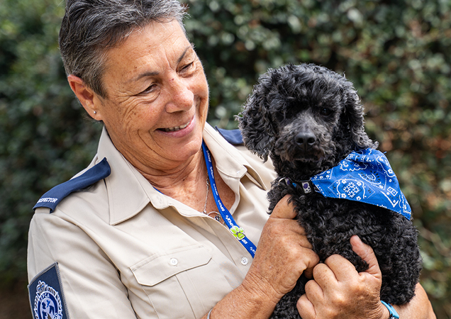 RSPCA Inspector with black puppy.